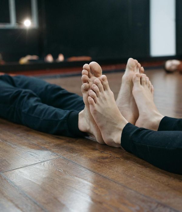 Person performing a calm and focused yoga pose in a minimalist space.